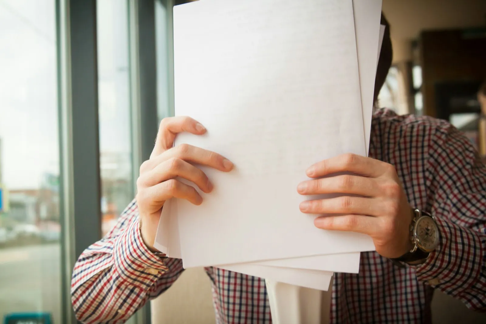 A candidate holding an identity document up to the camera