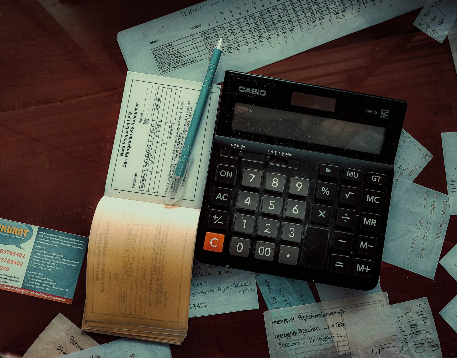 An invoice and calculator on a finance desk